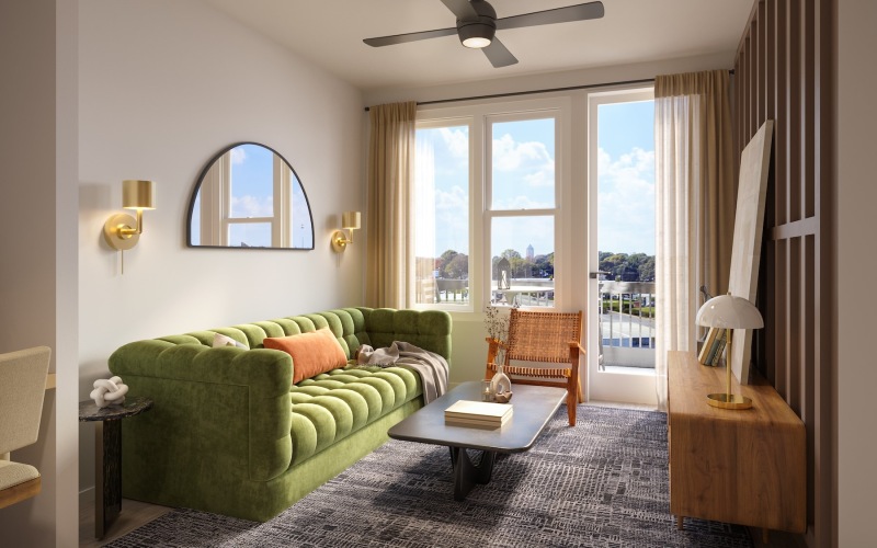 living room with a couch coffee table and windows