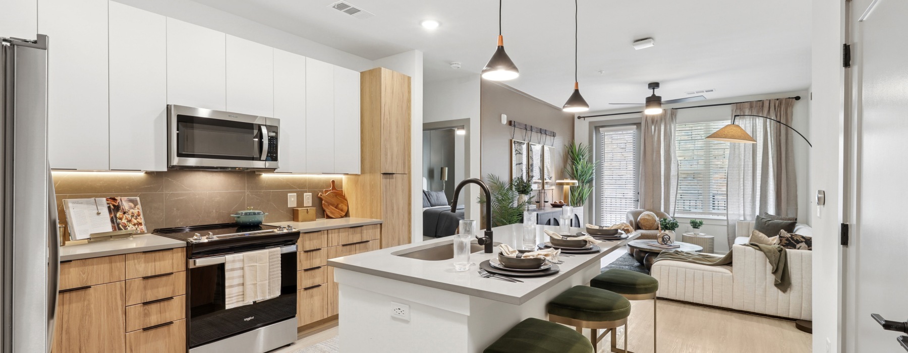 Sleek stainless-steel appliances, quartz countertops, and designer cabinetry