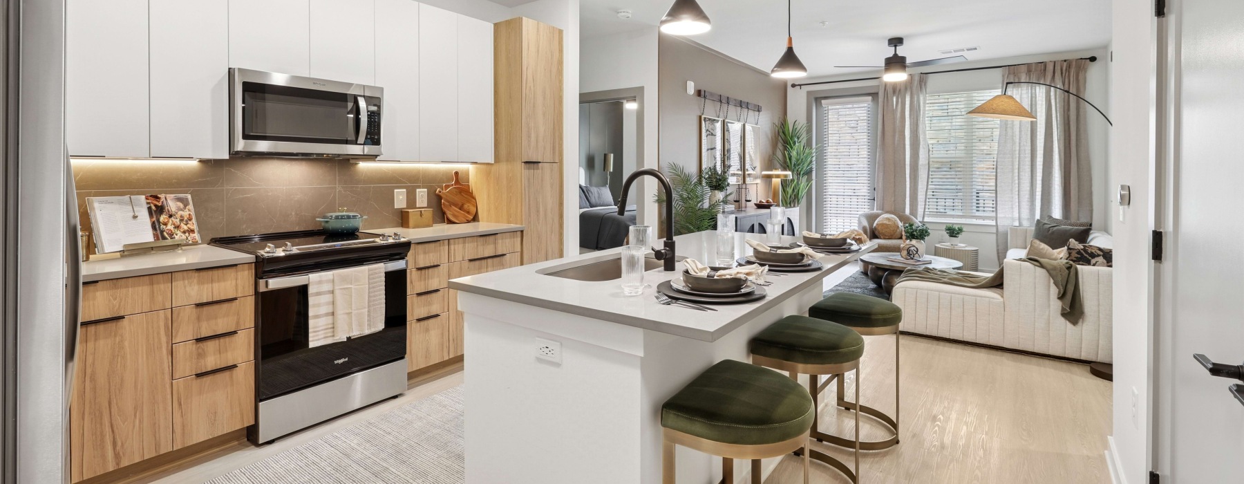 Kitchen with white cabinets and wood accents at Solis Peachtree Corners apartments